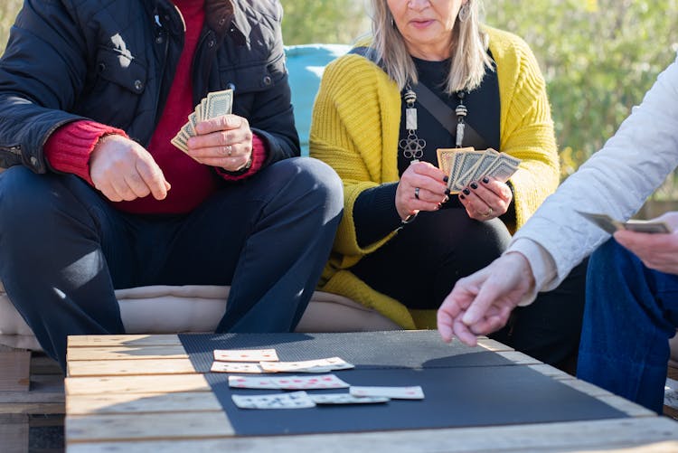 People Playing Cards On The Table