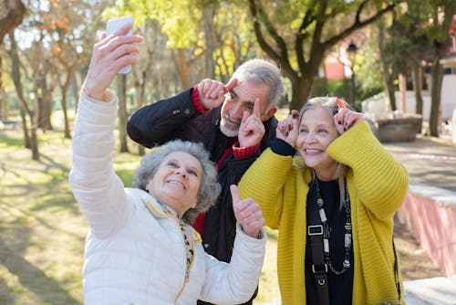 Three Elderly People Taking Group Selfie