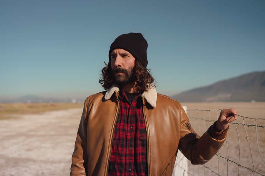 Man wearing a brown leather trucker jacket