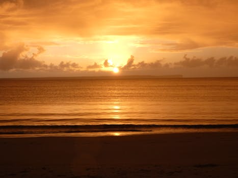 Experience the serene beauty of a golden sunset over Huskisson Beach in New South Wales, Australia.