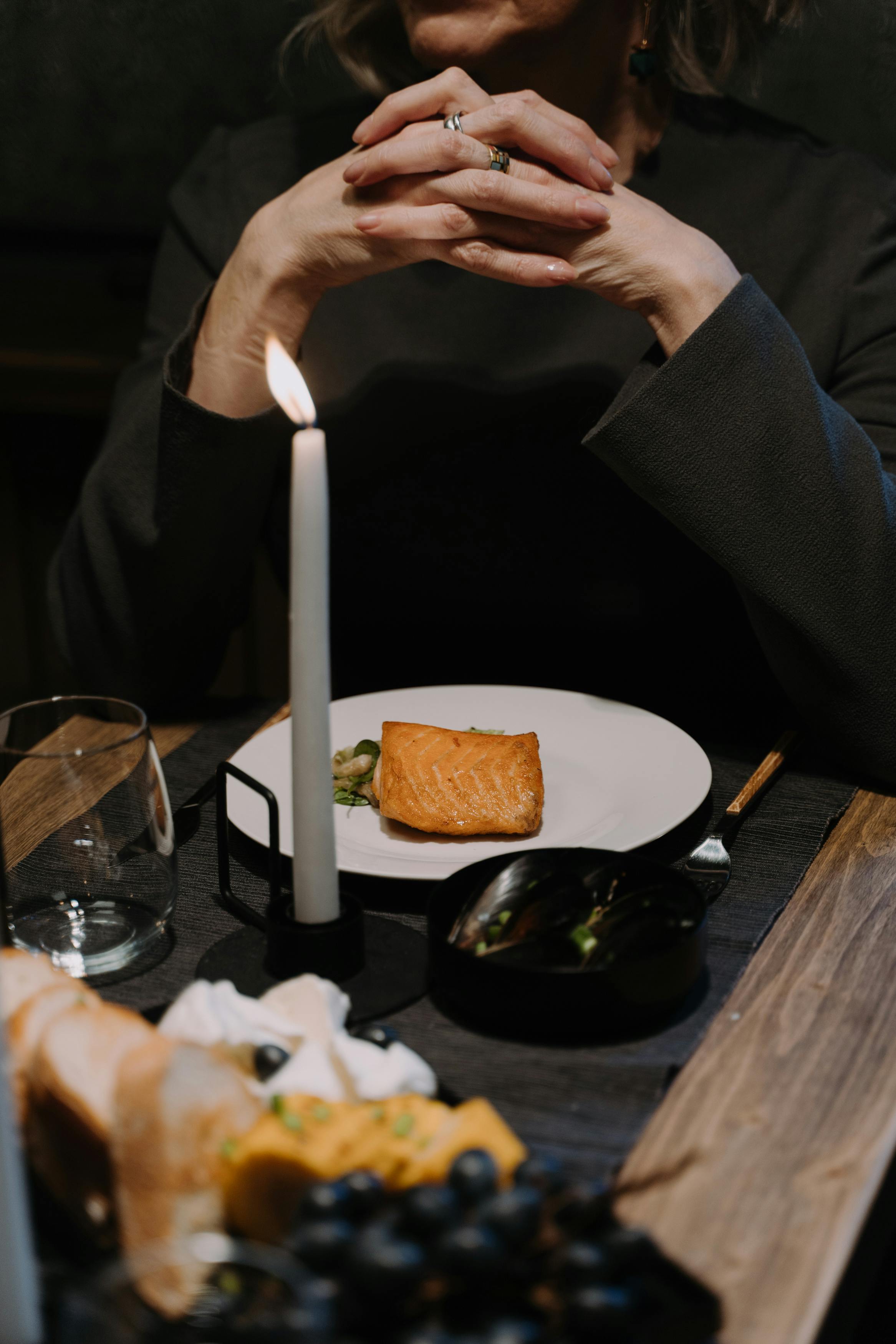 Free A Woman Praying Over Dinner Stock Photo