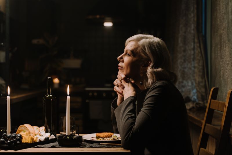 Mature woman enjoying a candlelit dinner