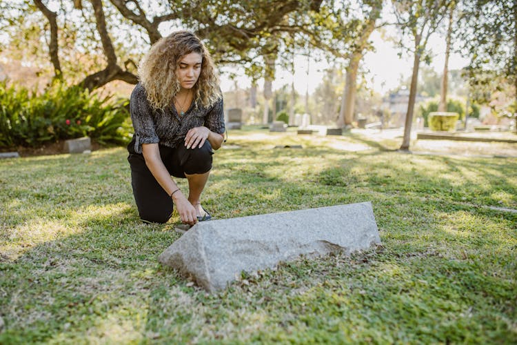 A Woman Visiting On The Cemetery