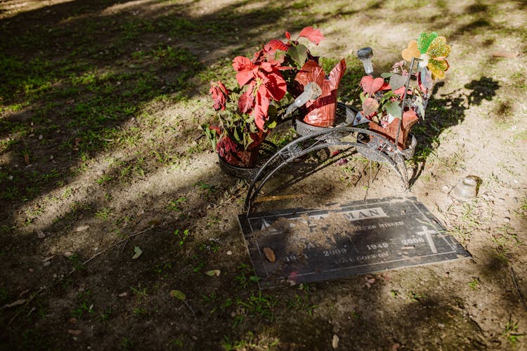 A Gravestone With Flowers