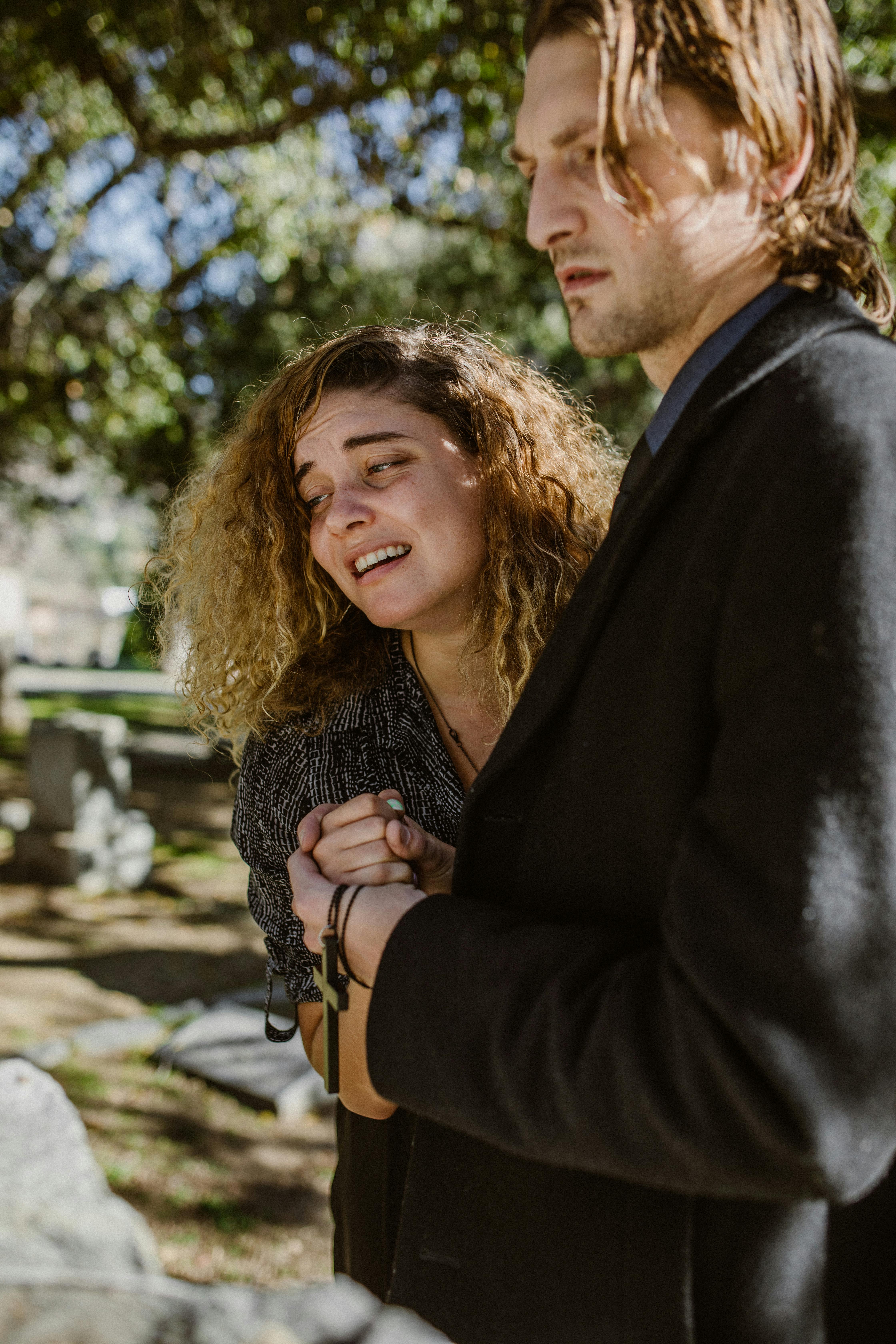 mourning woman held by a man