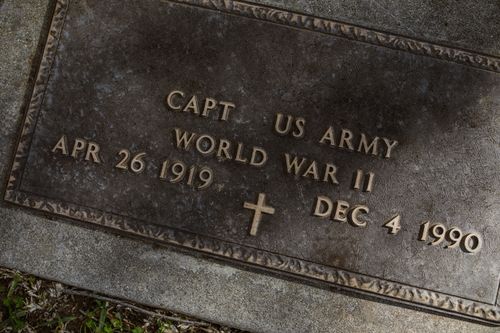 Free A close-up of a World War II US Army captain's gravestone with detailed inscription. Stock Photo