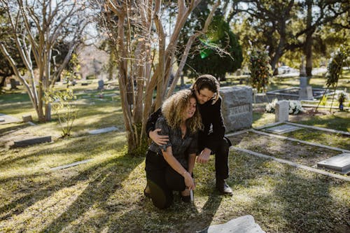 Free A Man and Woman Crying in the Cemetery Stock Photo
