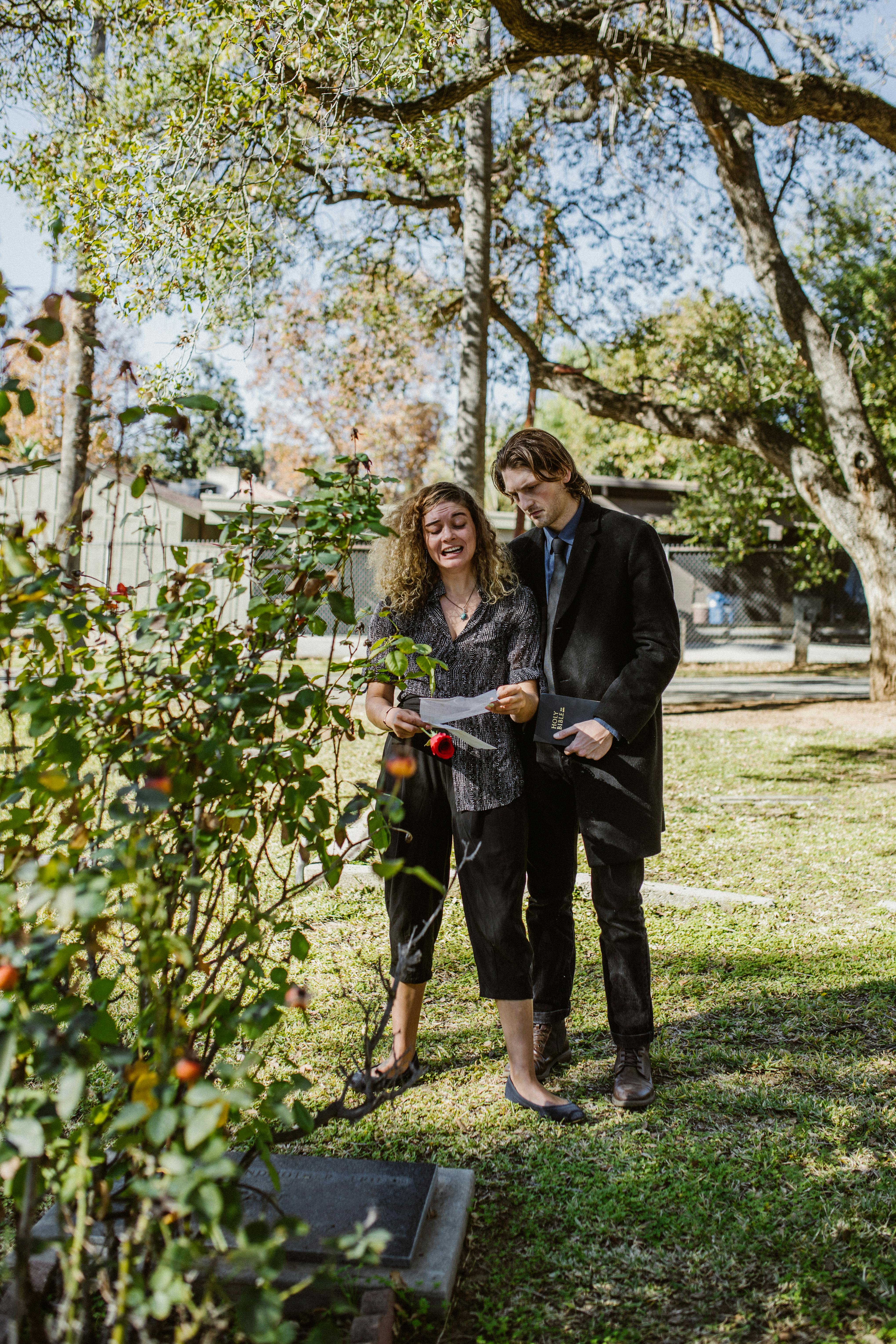 man and woman standing on green grass