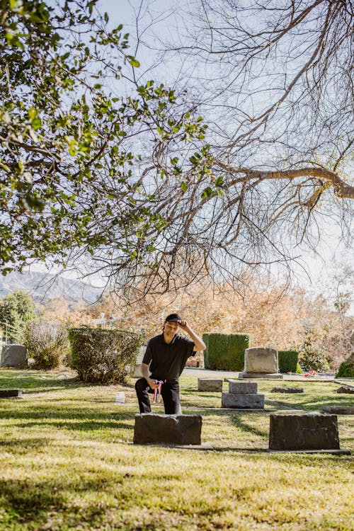 Free Man visiting a Grave of a Beloved Stock Photo