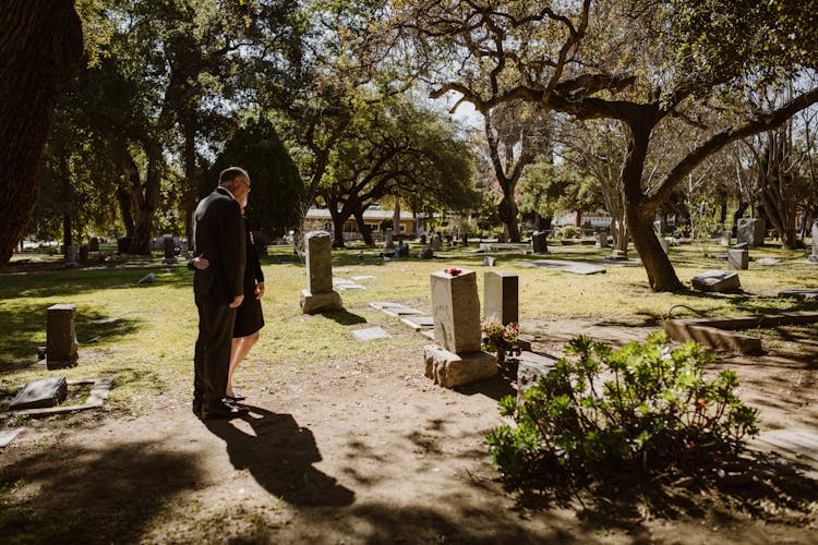 A Couple Grieving At The Cemetery