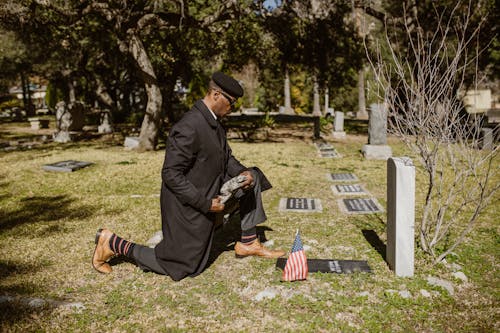 Free Man visiting a Grave of a Beloved Stock Photo