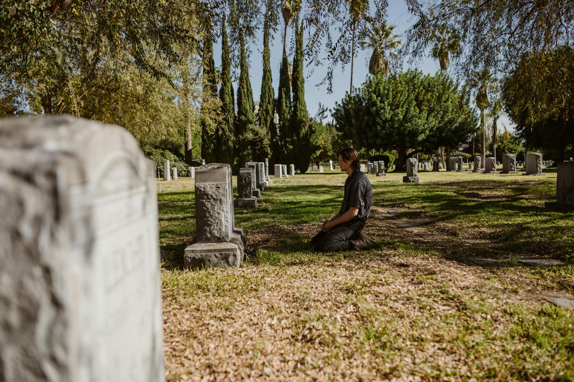 A Man In Front of the Tombstone