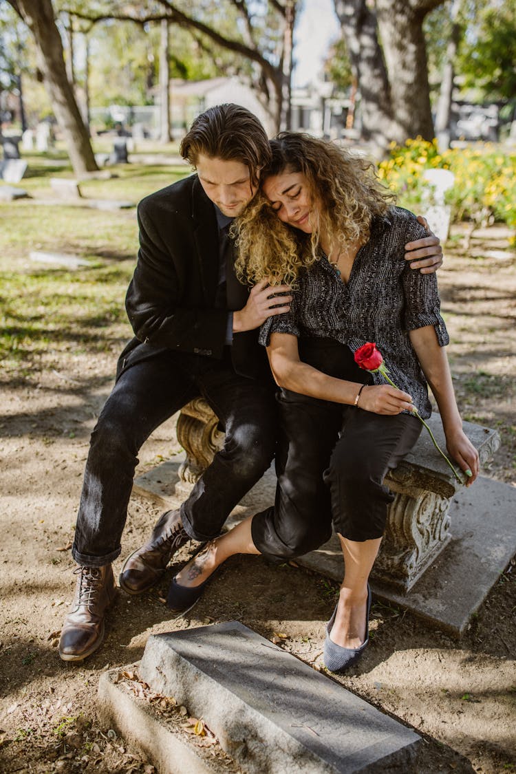 

A Man Consoling A Grieving Woman