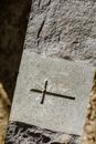 A Cross Engraved on a Concrete Surface