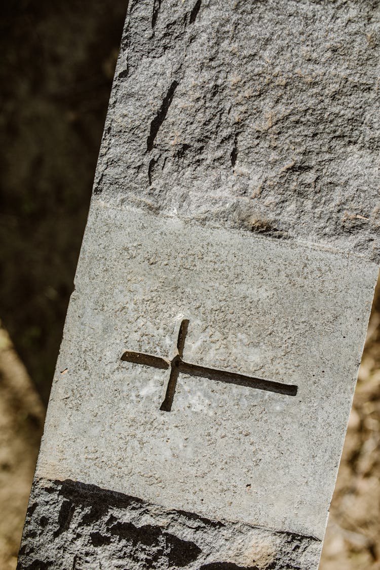 A Cross Engraved On A Concrete Surface