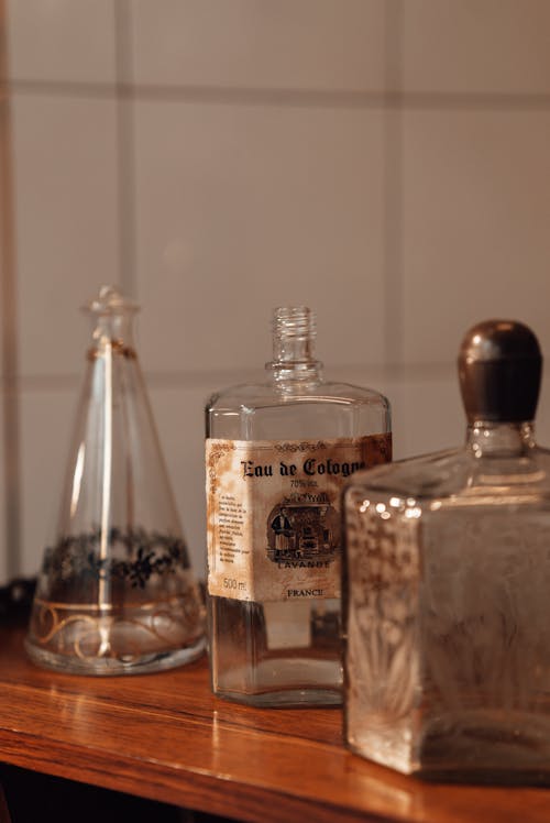 Assorted old empty bottles with inscription on shelf