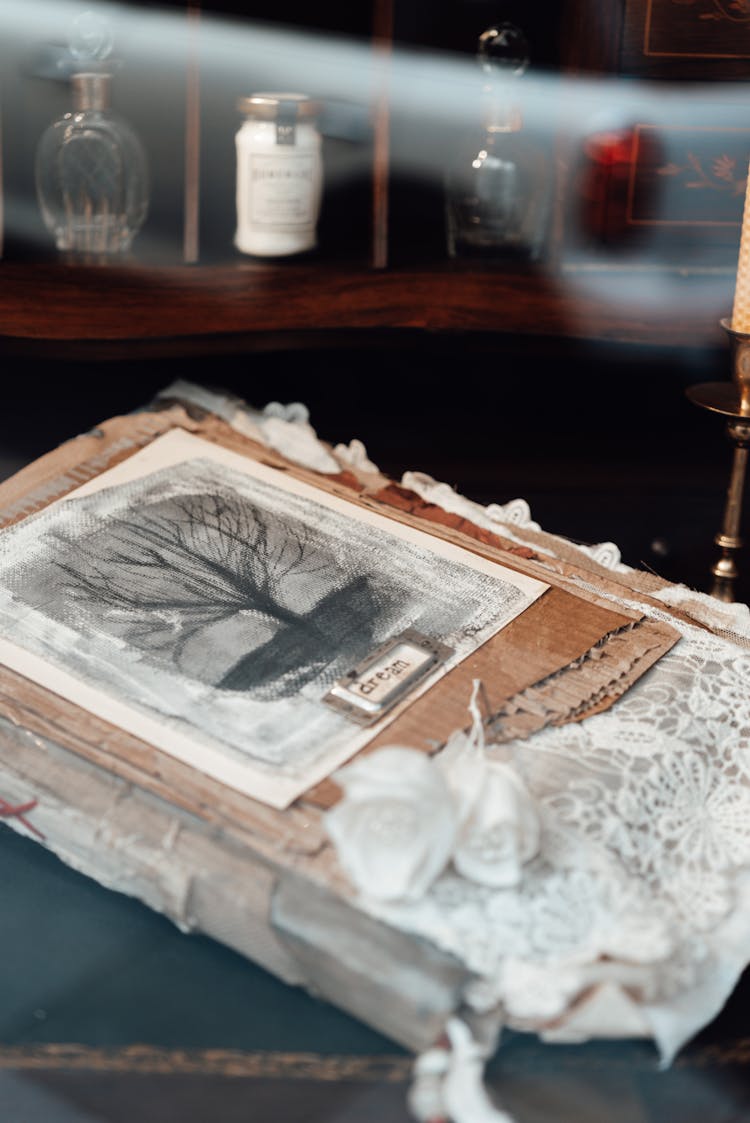 Artwork Of Tree Against Shelf With Decanters Indoors