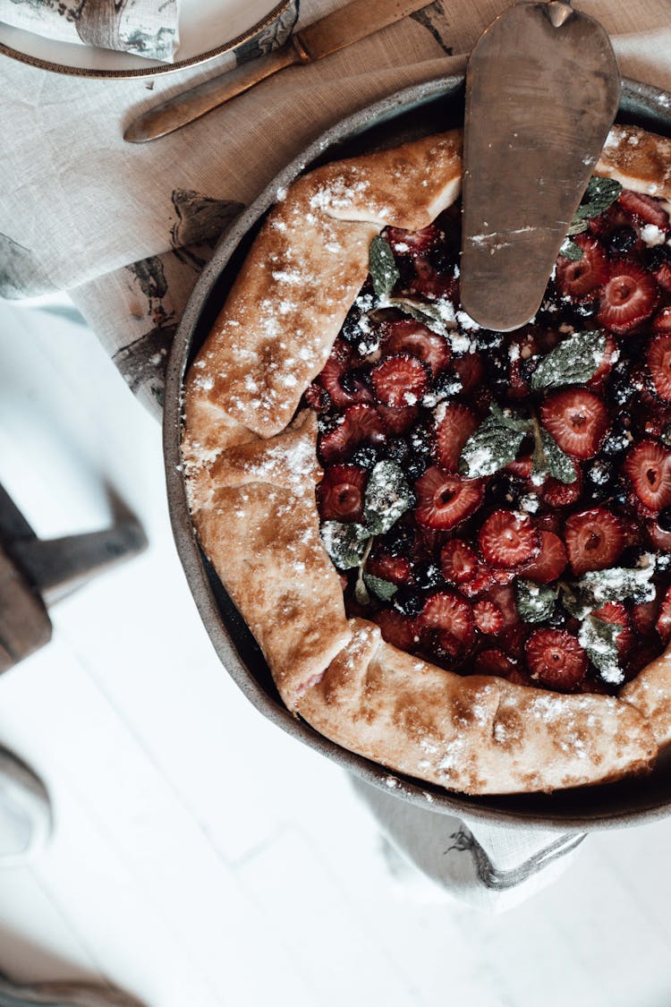 Delicious Berry Pie With Icing Sugar In Baking Pan