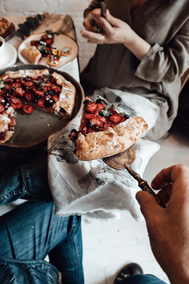 Crop Friends With Delicious Berry Pie At Table