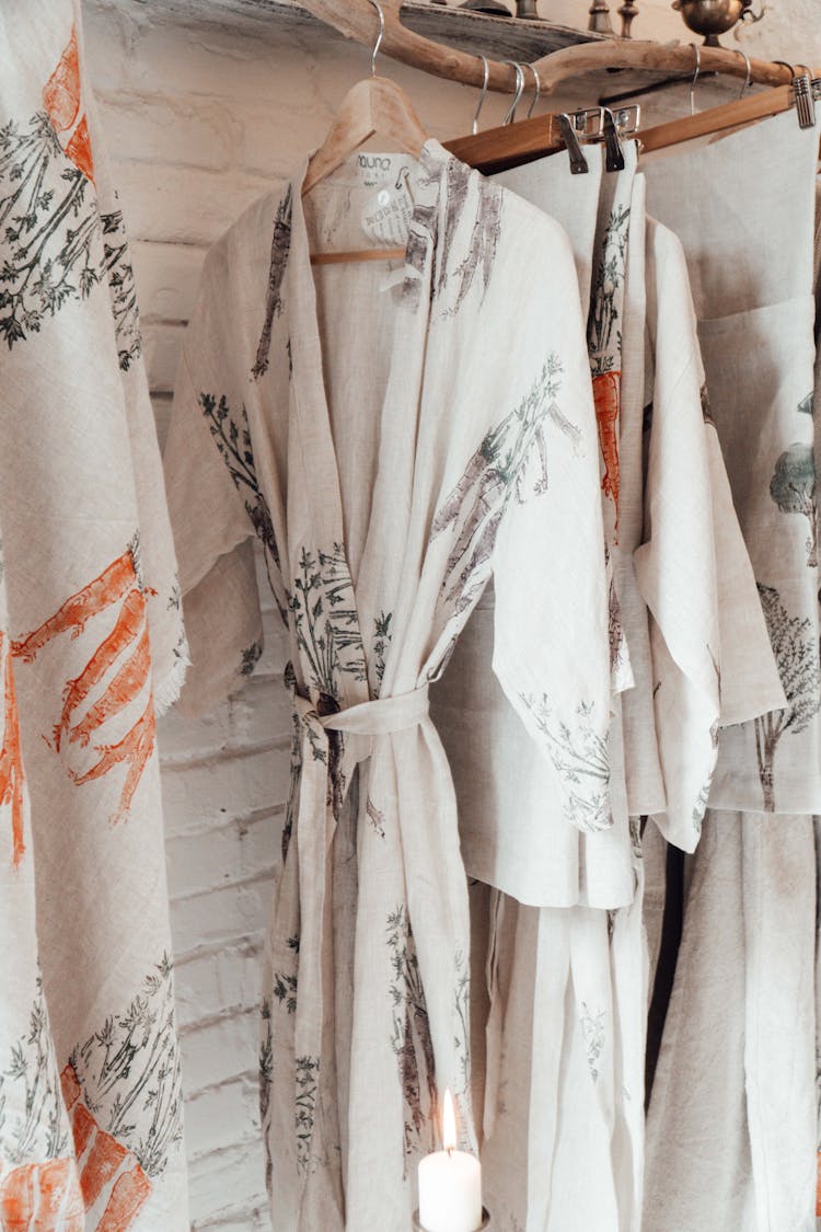 Robe And Textiles With Ornament On Hangers Indoors