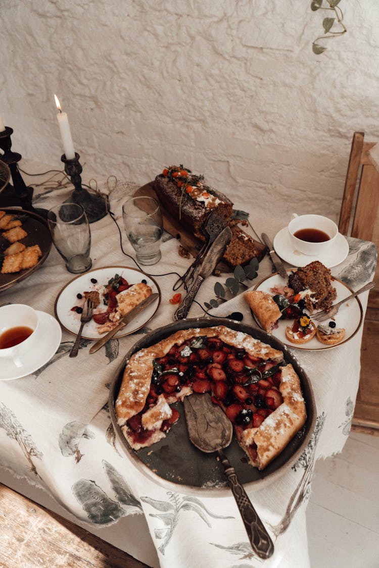 Tasty Berry Pie And Bread On Table In House