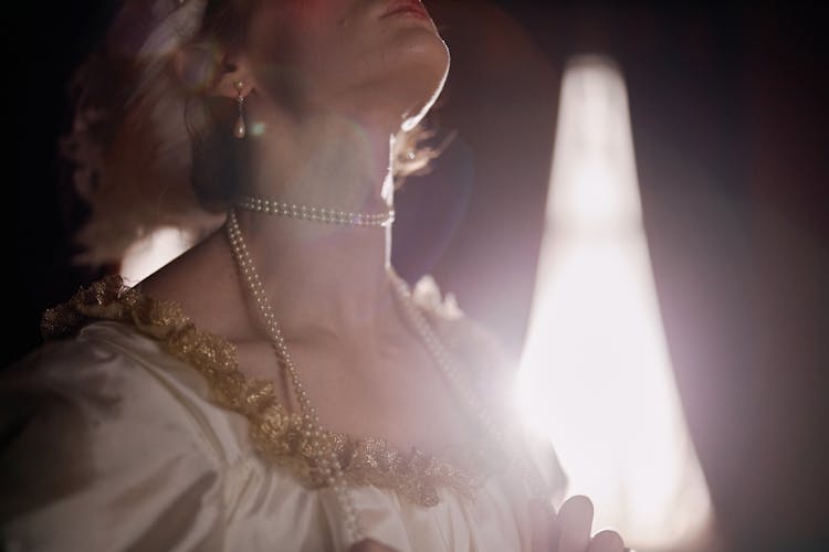 A Woman Wearing A Pearl Necklace