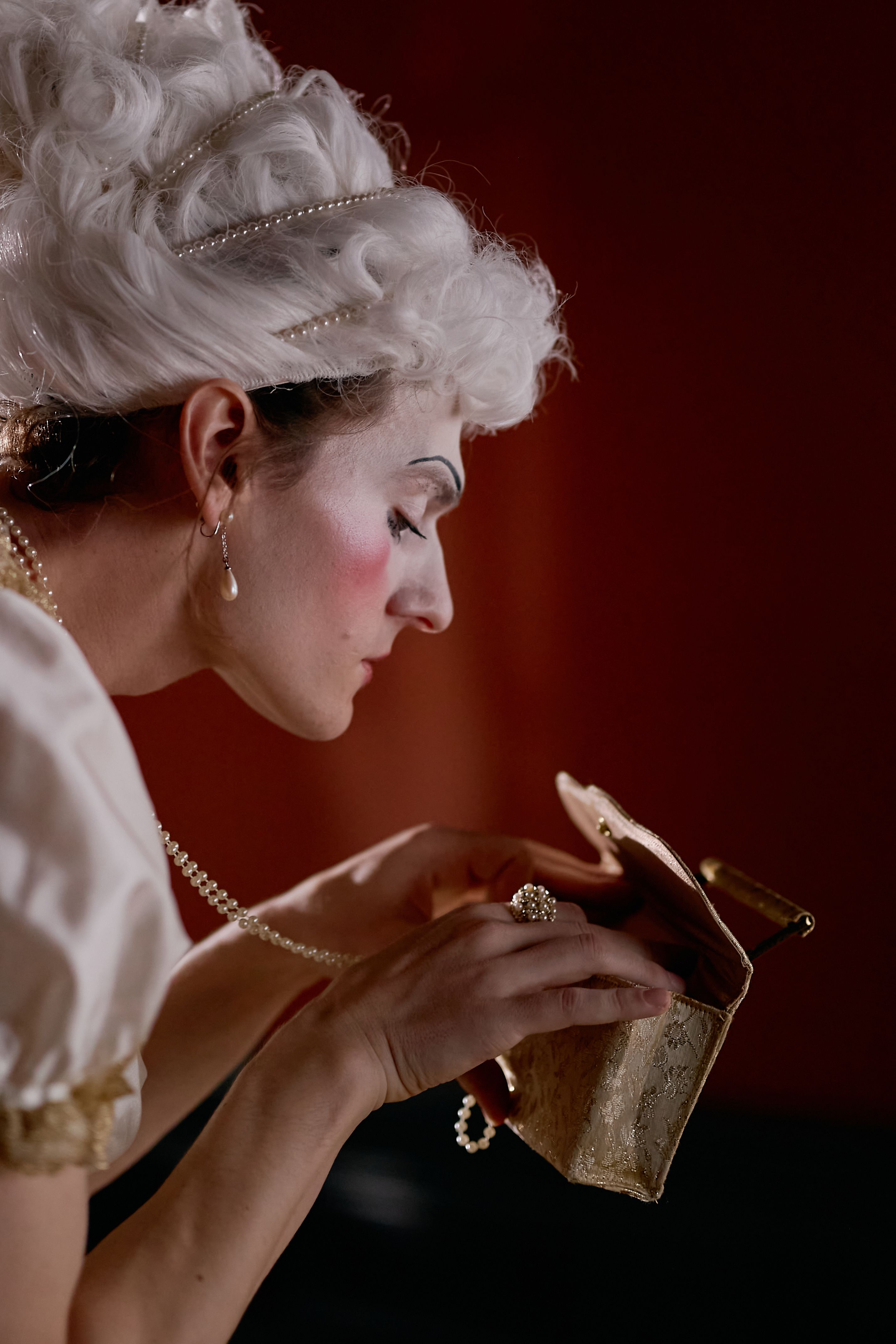 A captivating portrait of a person donning a vintage costume and makeup, embracing a classic style.
