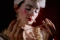 Person Holding a Pearl Necklace