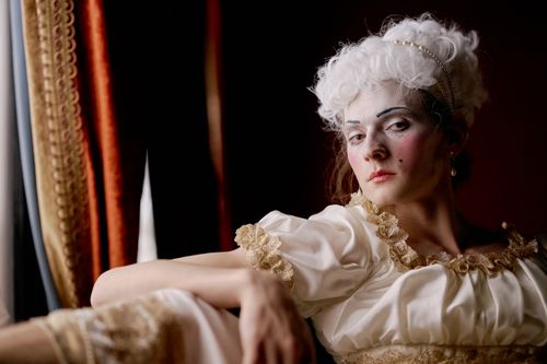 Free A captivating portrait of a woman in 18th-century costume with intricate makeup. Stock Photo
