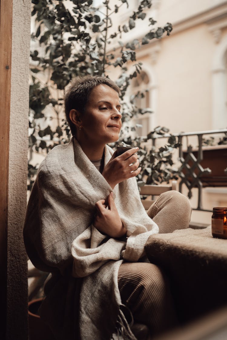 Smiling Woman Enjoying Coffee Scent On Balcony