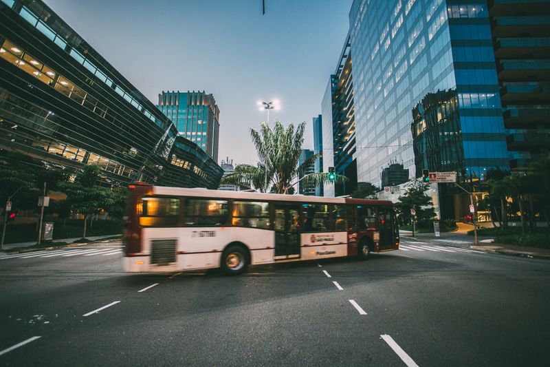 Modern white city bus on a road during the daytime