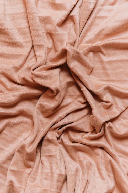Free A detailed shot of soft pink satin fabric with elegant wrinkles and folds. Stock Photo