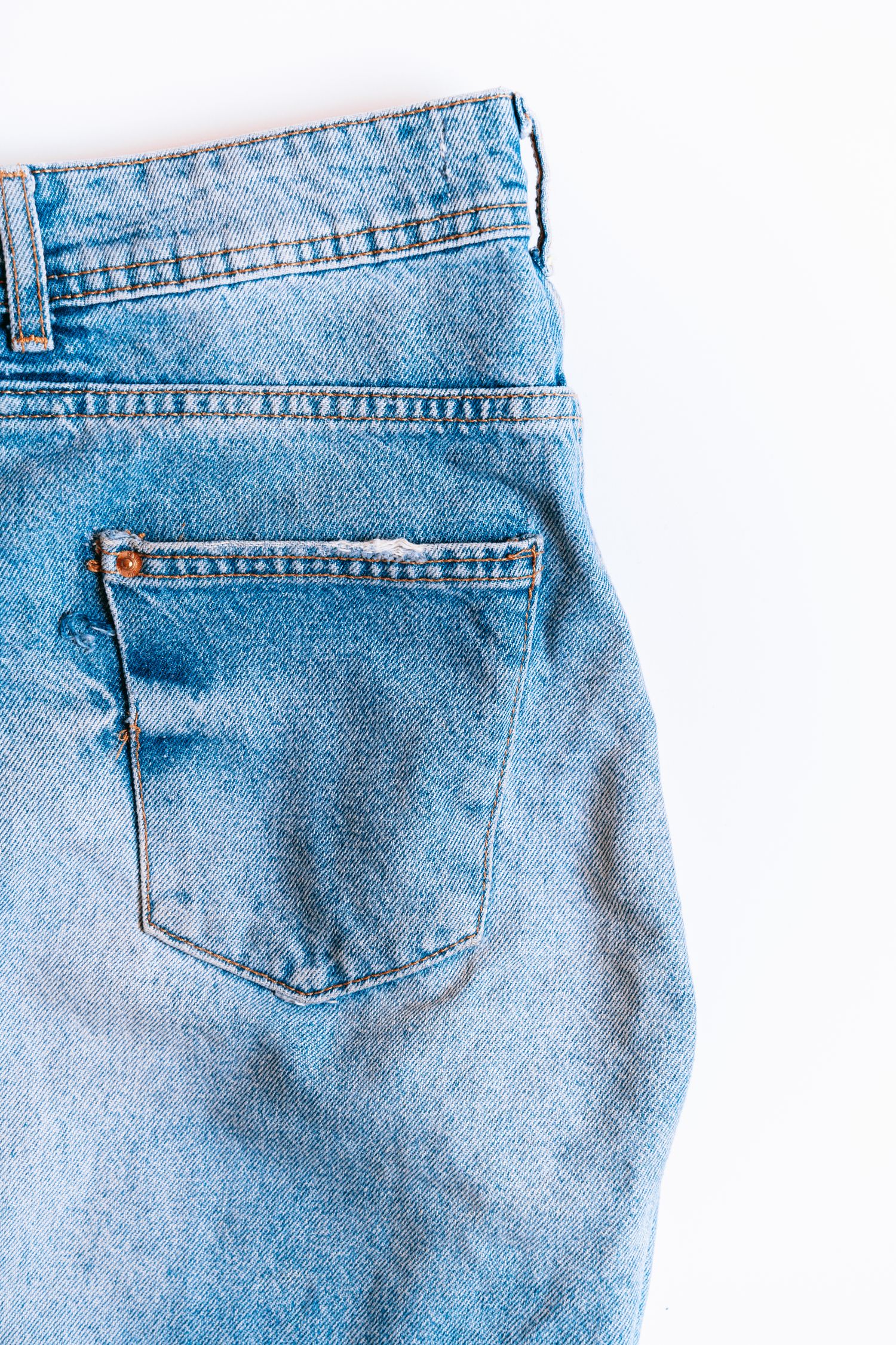 Close-up of a denim back pocket showing pocket shape, placement and stitching