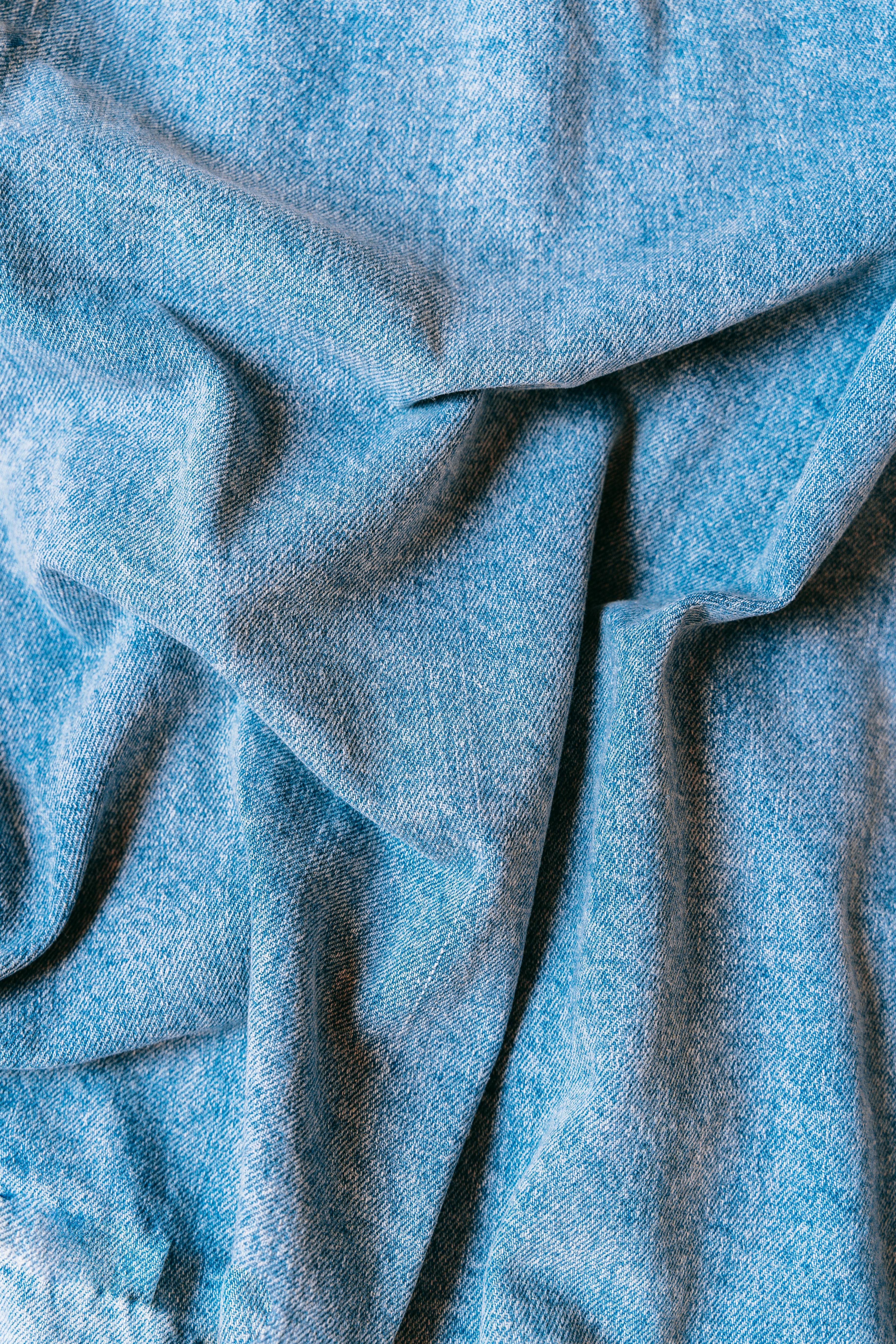 blue denim textile in close photography