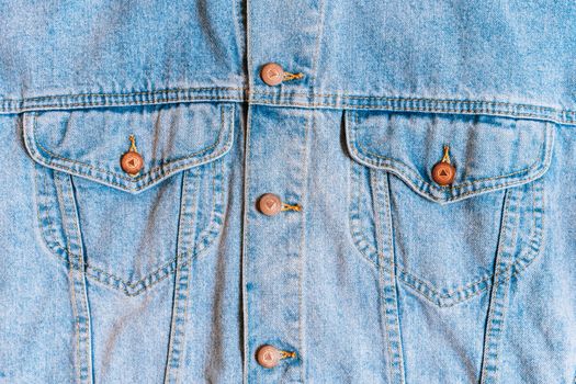High-resolution close-up of a denim jacket showcasing button and pocket details, perfect for fashion themes.