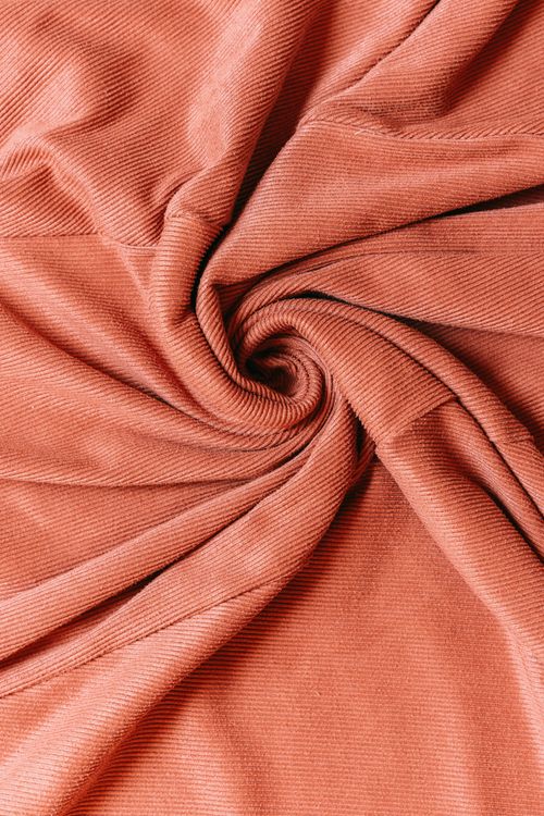Free Detailed texture of a swirling pink corduroy fabric pattern. Stock Photo