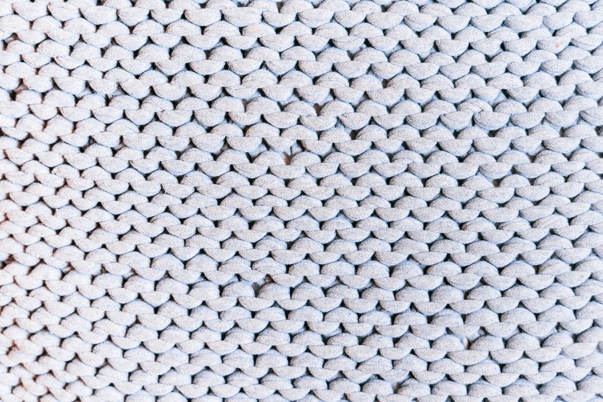 Macro shot of looped cotton pile fabric showing the raised loops that give terry tea towels their extra absorbency