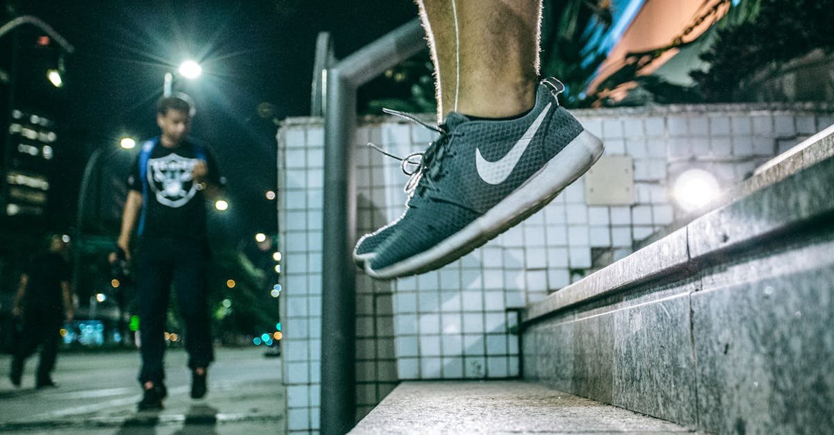Man in Black White Nike Shoes during Nighttime