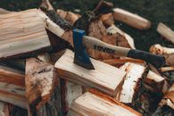 Axe in dry firewood in countryside in daytime