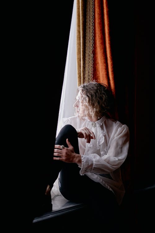 Man Wearing a Lace Cravat Sitting Beside the Window