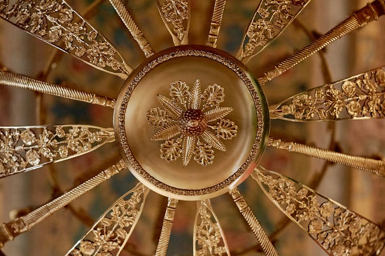 A Round Gold Floral Design In Close-up Shot