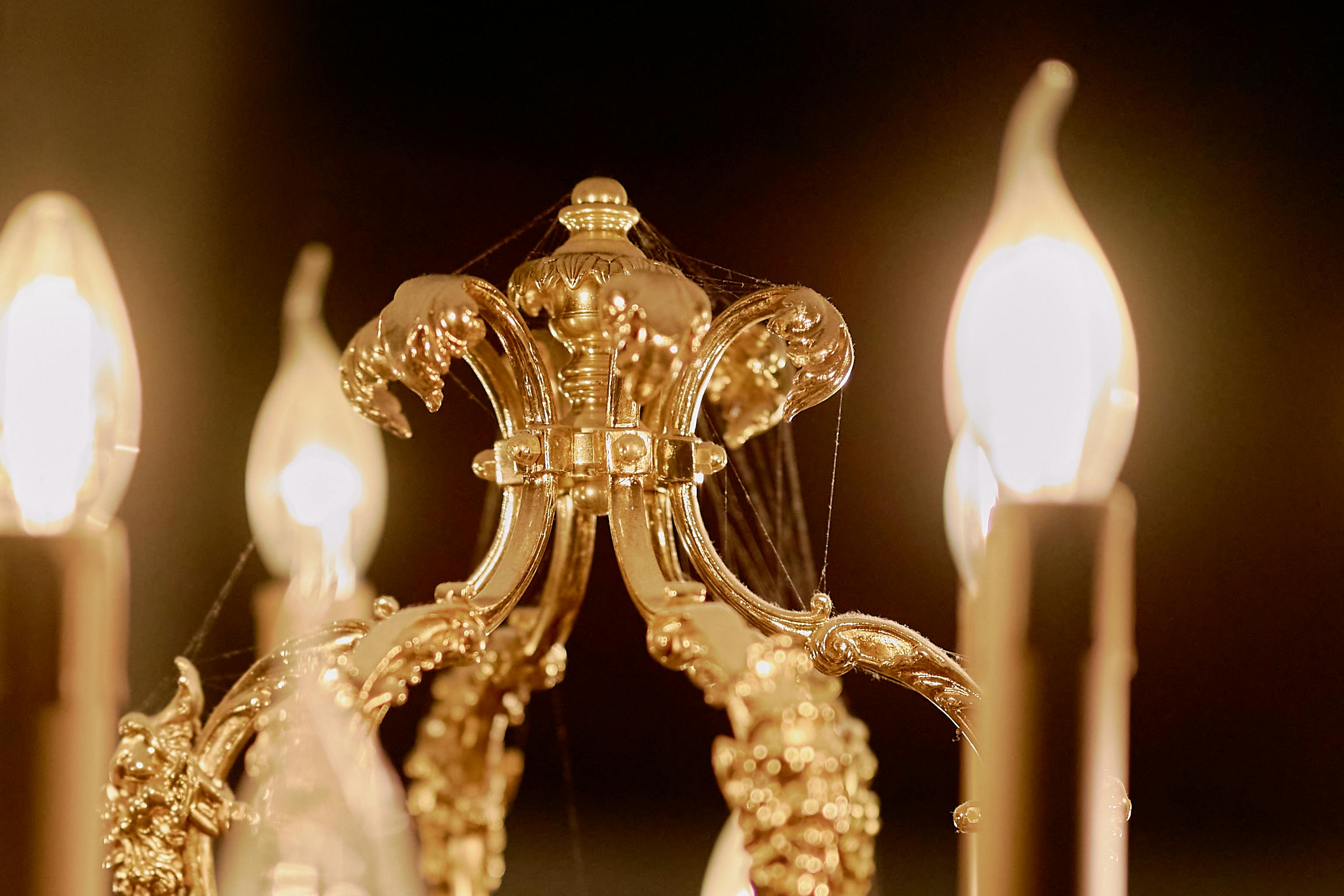 a gold lamp with spiderweb