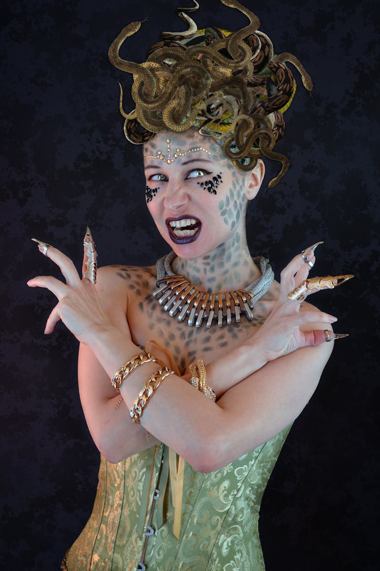 Furious Young Woman In Medusa Outfit Roaring And Looking At Camera