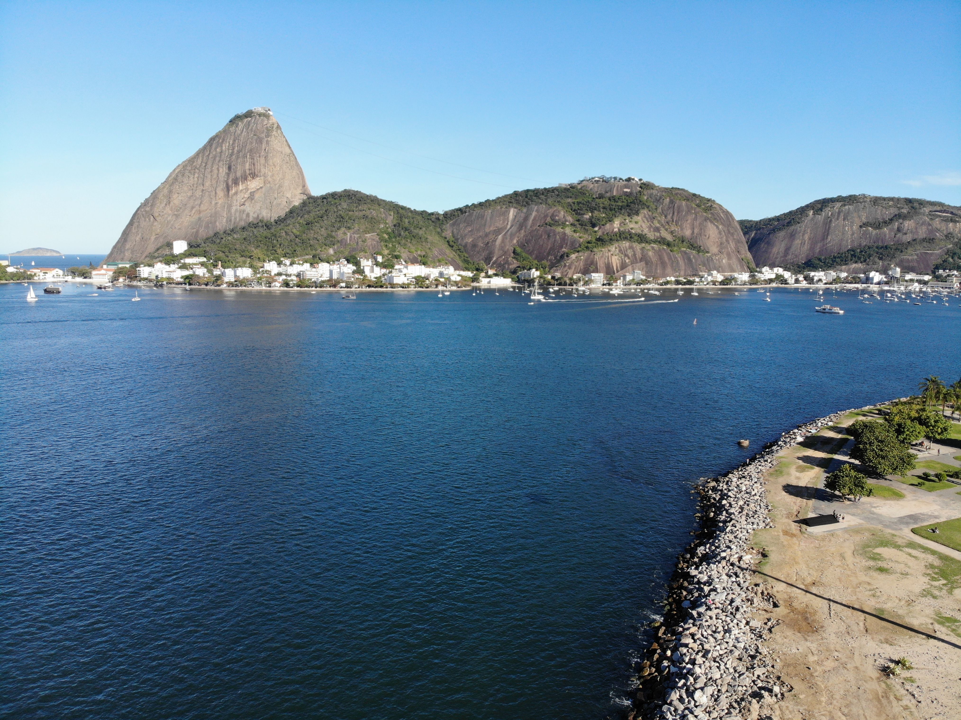 Best Rio de Janeiro: 35 Minutes Doorless Helicopter Tour Christ Review Review 2026 - Aerial view of Sugarloaf Mountain and Guanabara Bay in Rio de Janeiro, Brazil, on a clear sunny day.