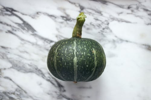 Green Young Squash on Marble Table