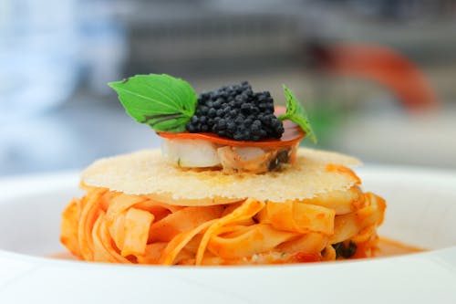 A Delicious Pasta Topped with black Caviar