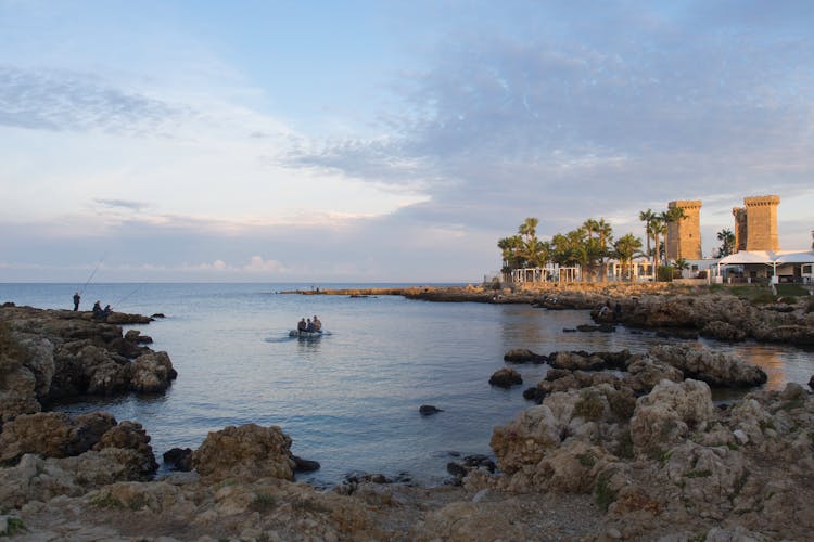 Fishermen And People On Pontoon On Sea Shore