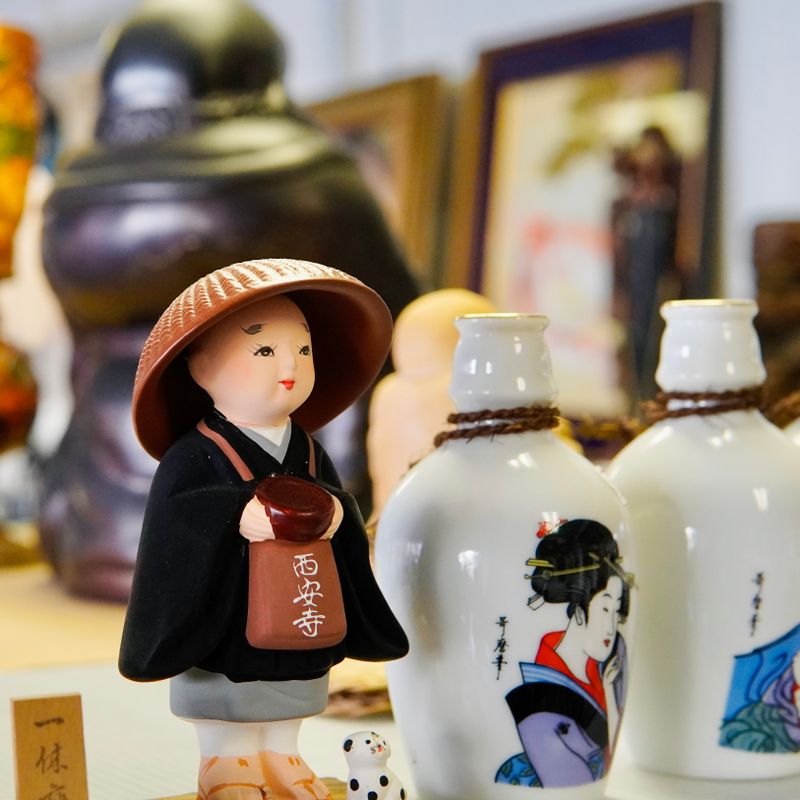 Shelf with various collectibles representing beginner art toy collection guide including BaiChaoHui figures