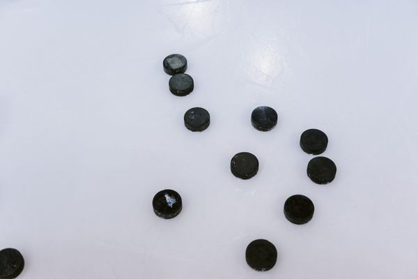 Warm-up pucks scattered across fresh ice — photo by Tima Miroshnichenko on Pexels