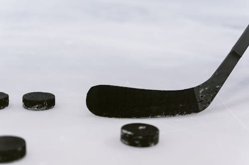 Close Up Shot of a Hockey Puck and Hockey Stick